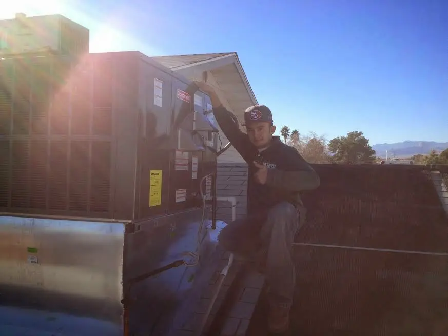 HVAC technician performing HVAC Inspection on a rooftop unit in Walterboro